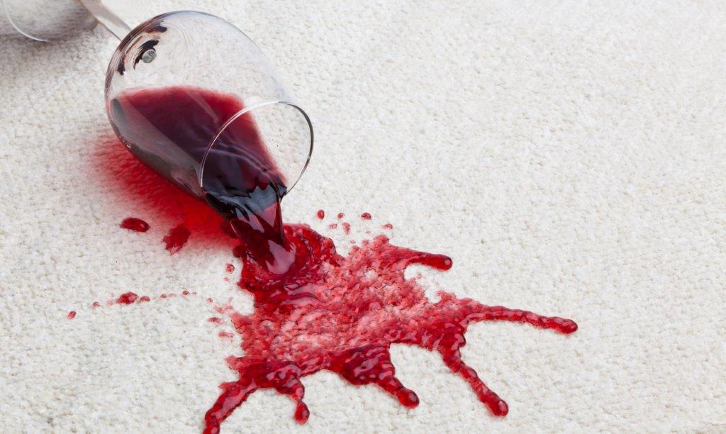 red wine spilled on clean carpet rug